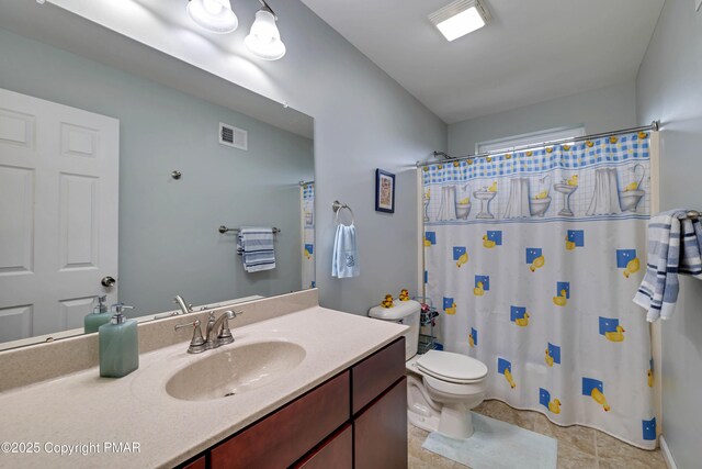 bathroom featuring vanity, toilet, and walk in shower