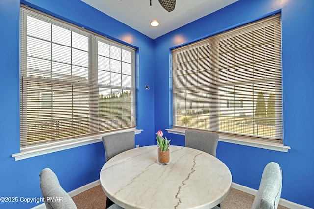 carpeted dining space with plenty of natural light