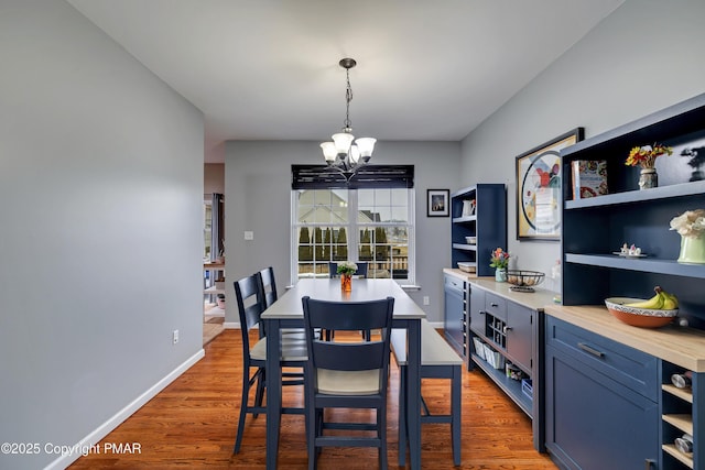 dining area featuring an inviting chandelier and hardwood / wood-style floors