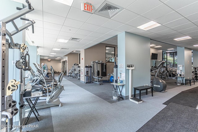 workout area with a drop ceiling and visible vents