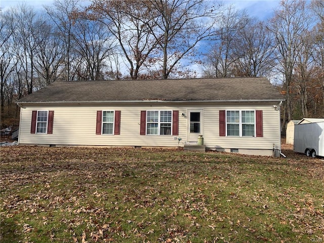 single story home with crawl space, an outbuilding, and a front lawn