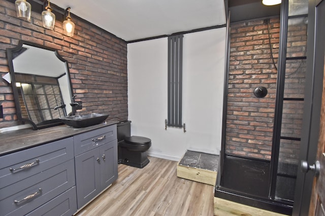 207 Shepard Ave, Delaware Water Gap, PA 18327 - bathroom with brick wall, vanity, toilet, wood finished floors, and baseboards