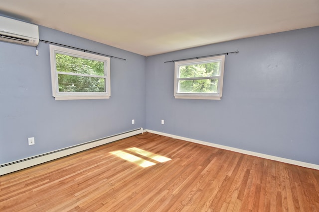 207 Shepard Ave, Delaware Water Gap, PA 18327 - spare room with a wall mounted air conditioner, a baseboard heating unit, wood finished floors, and baseboards