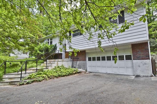 207 Shepard Ave, Delaware Water Gap, PA 18327 - view of home's exterior with brick siding, a garage, and driveway