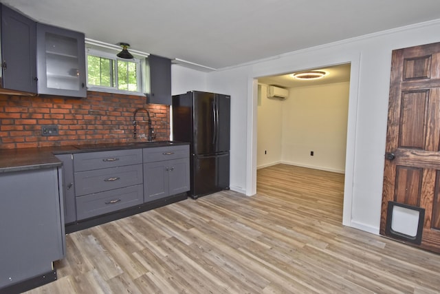 207 Shepard Ave, Delaware Water Gap, PA 18327 - kitchen with freestanding refrigerator, dark countertops, light wood-type flooring, gray cabinetry, and glass insert cabinets