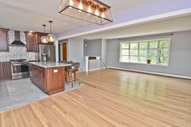 207 Shepard Ave, Delaware Water Gap, PA 18327 - kitchen with stainless steel appliances, wall chimney exhaust hood, a kitchen bar, decorative backsplash, and light stone countertops