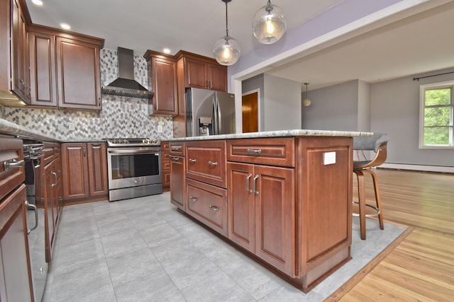 207 Shepard Ave, Delaware Water Gap, PA 18327 - kitchen with wall chimney range hood, appliances with stainless steel finishes, a kitchen island, a baseboard heating unit, and a breakfast bar