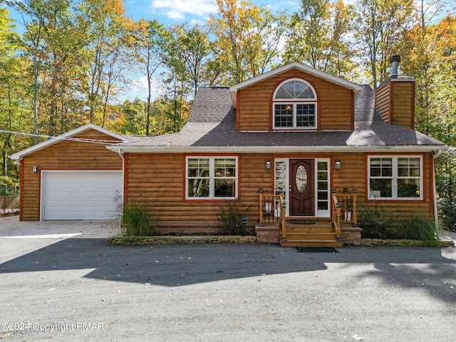 view of front of property featuring roof with shingles, a chimney, and faux log siding