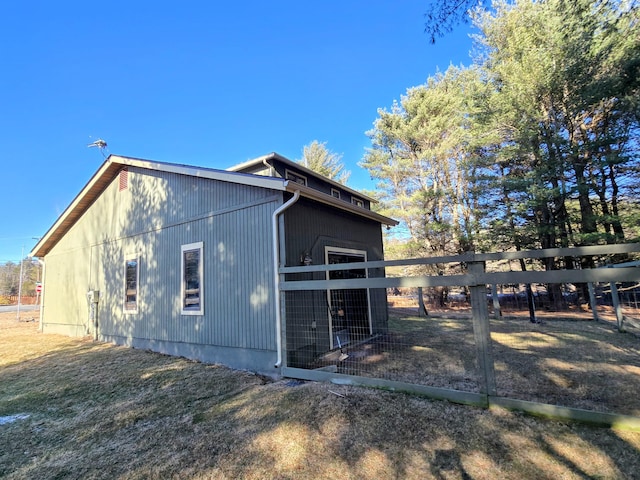 view of side of property featuring fence