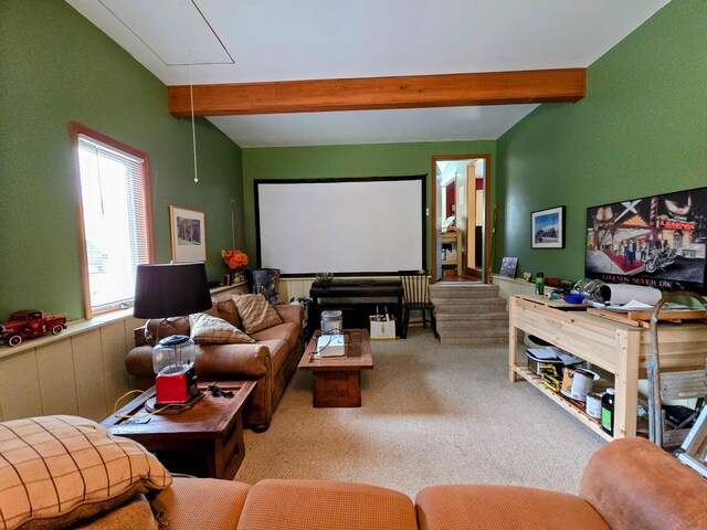 home theater room with carpet and beam ceiling