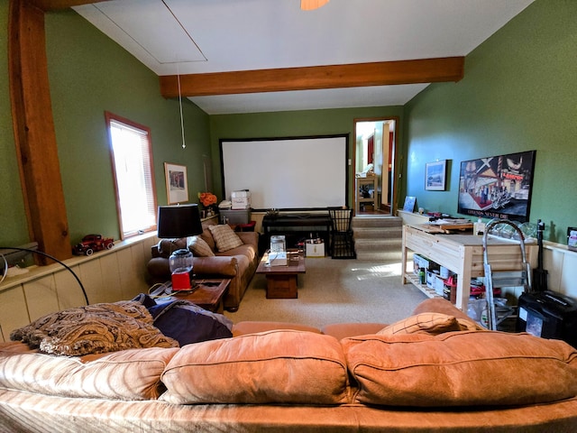 home theater room featuring vaulted ceiling with beams and carpet