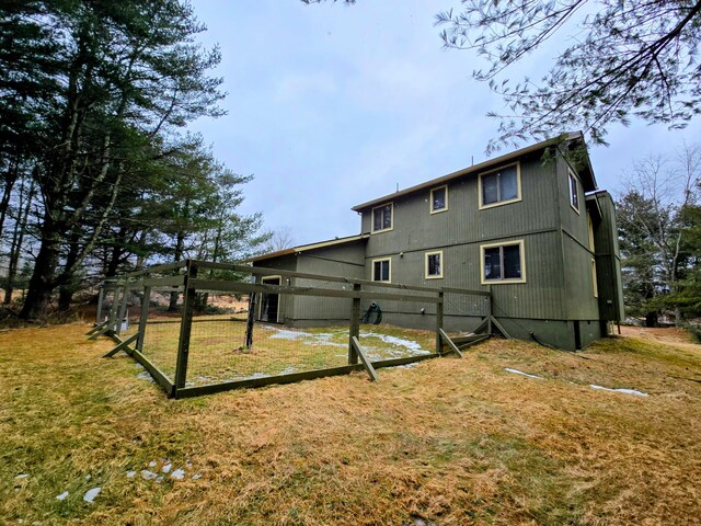 rear view of house featuring a yard