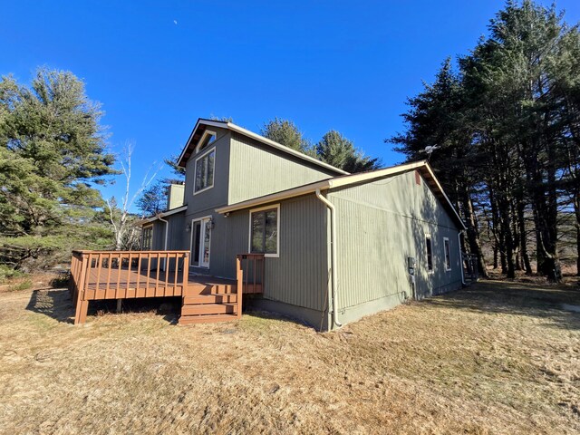 view of home's exterior featuring a wooden deck