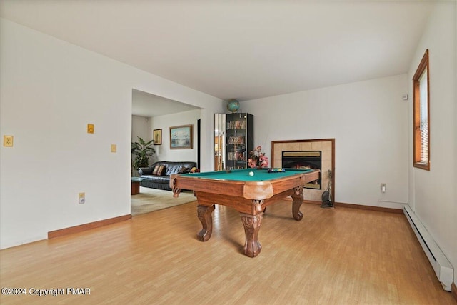 playroom featuring a tile fireplace, pool table, baseboards, baseboard heating, and light wood-type flooring