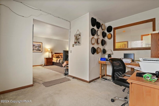 carpeted office featuring baseboards