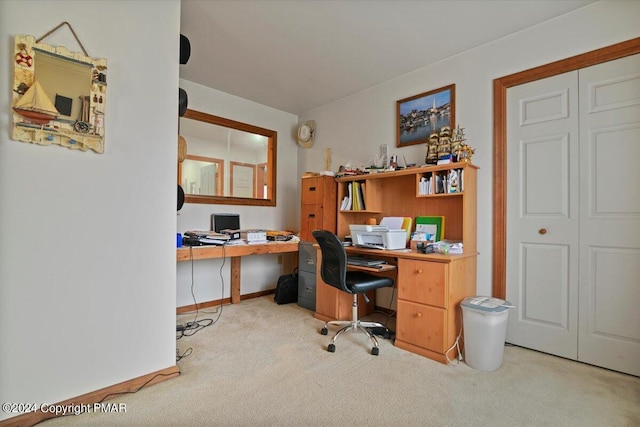 carpeted home office with baseboards