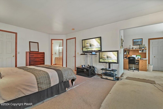 carpeted bedroom featuring ensuite bathroom