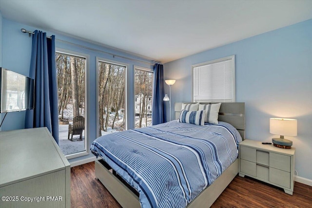 bedroom featuring dark wood-type flooring and access to outside