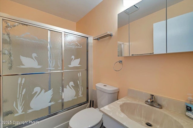 full bathroom featuring enclosed tub / shower combo, vanity, and toilet