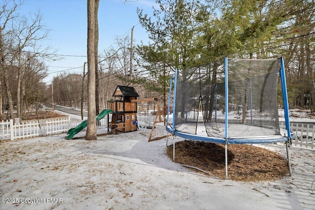 snow covered playground with a trampoline