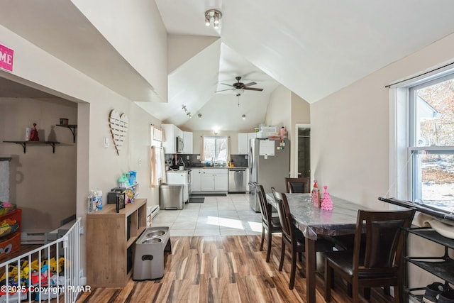 dining area with lofted ceiling, ceiling fan, light hardwood / wood-style floors, and a healthy amount of sunlight