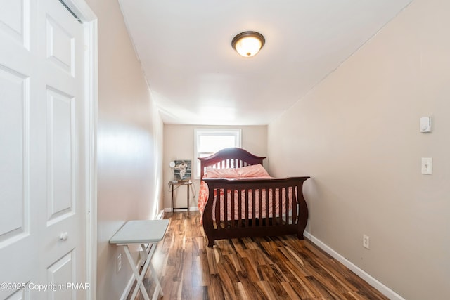 bedroom with dark wood-type flooring