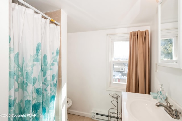 bathroom with baseboard heating, toilet, sink, and a wealth of natural light