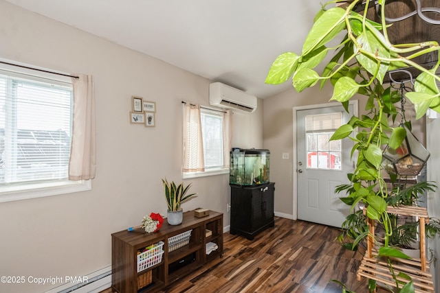 foyer featuring a healthy amount of sunlight, an AC wall unit, a baseboard heating unit, and dark hardwood / wood-style flooring