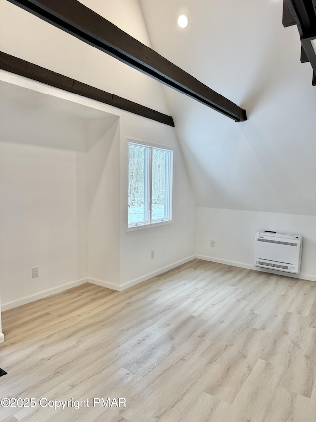 bonus room featuring heating unit, lofted ceiling with beams, baseboards, and wood finished floors