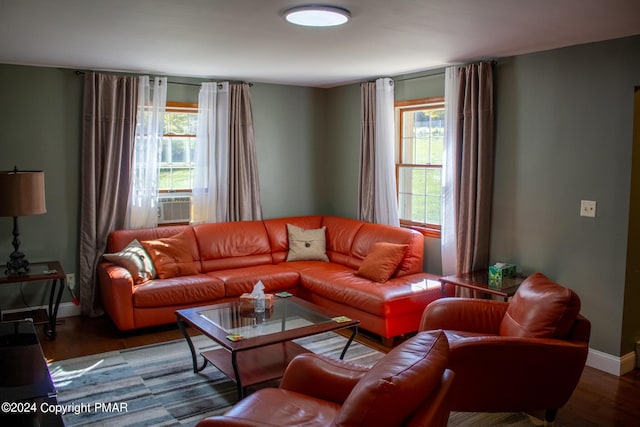 living room featuring a wealth of natural light, baseboards, and wood finished floors