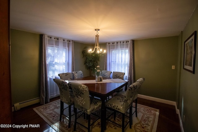 dining room with a baseboard heating unit, a notable chandelier, baseboards, and wood finished floors