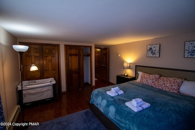 bedroom featuring baseboard heating and wood finished floors