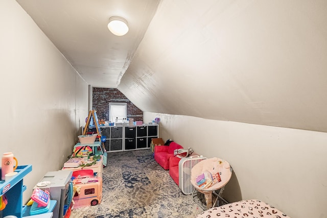 rec room with carpet floors and vaulted ceiling