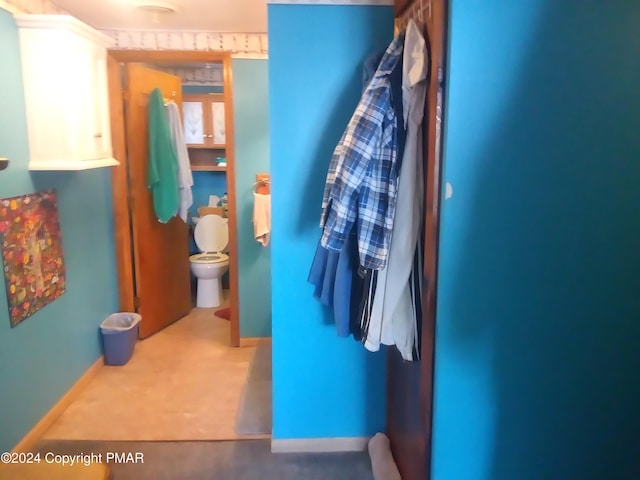 bathroom featuring toilet and baseboards