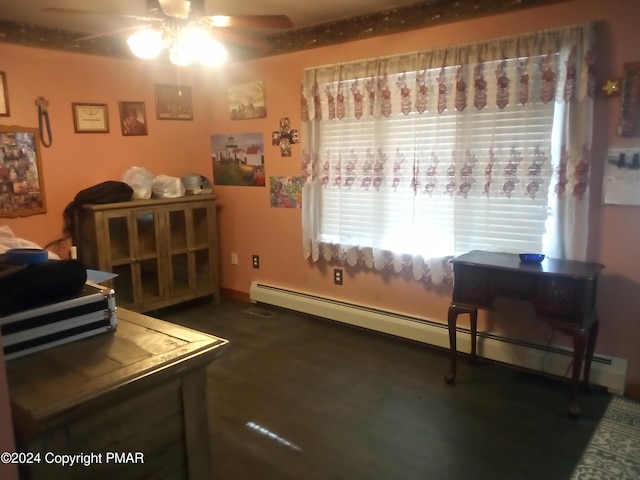 interior space featuring a baseboard radiator, ceiling fan, and wood finished floors