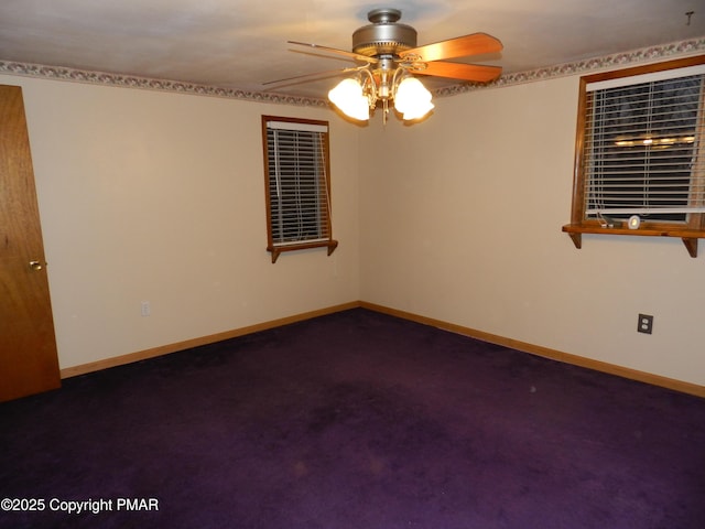 spare room featuring a ceiling fan, dark carpet, and baseboards