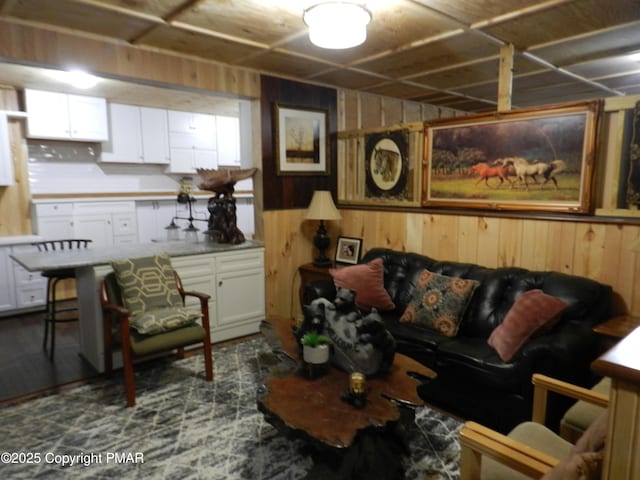 living room featuring wood walls