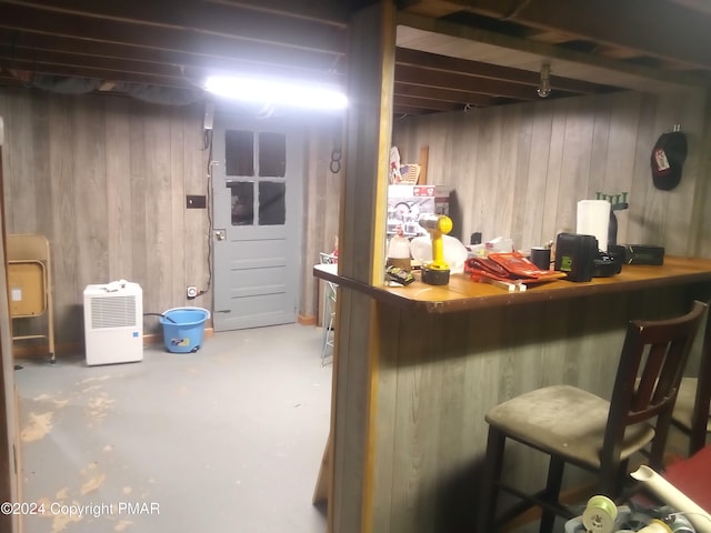 bar with concrete floors and wooden walls