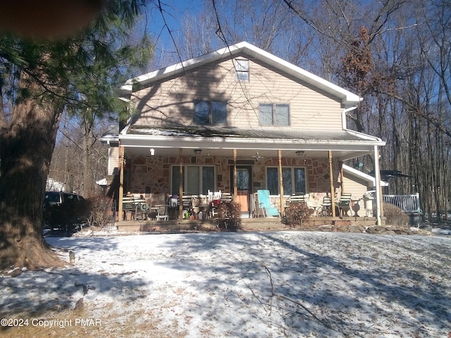 view of front of property featuring a porch and stone siding