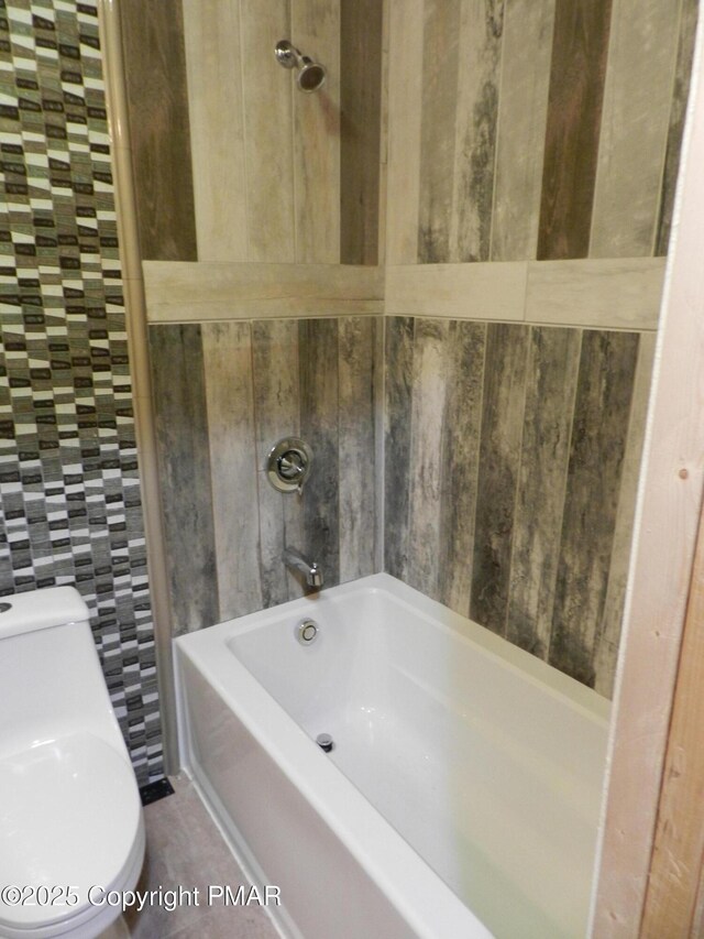 bathroom with shower / bathtub combination and toilet