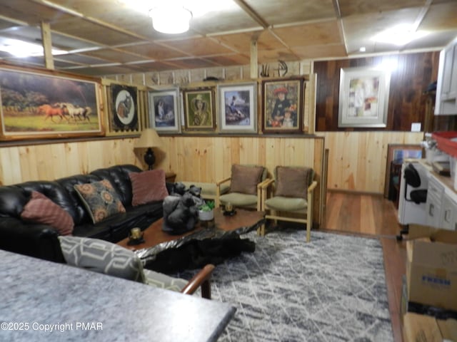 living room with wood walls and wood finished floors