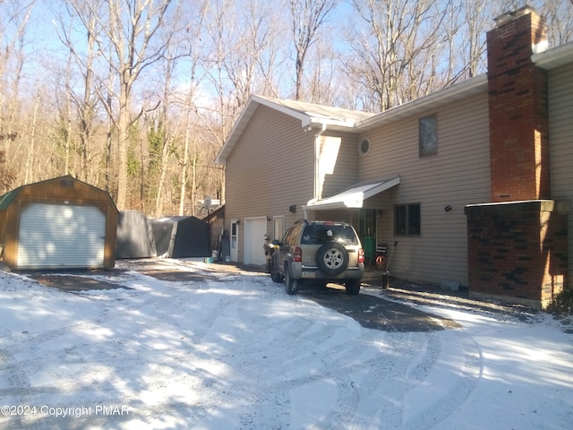 snow covered property featuring a garage