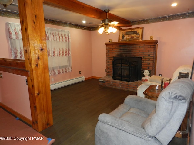 living room with dark wood-type flooring, ceiling fan, a fireplace, a baseboard radiator, and beamed ceiling