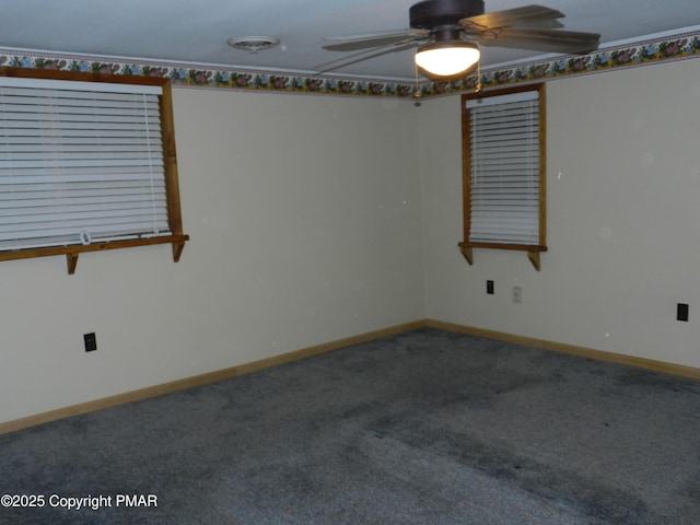 spare room with ceiling fan, carpet flooring, and baseboards