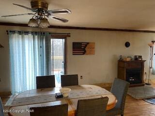 dining room featuring ornamental molding, wood-type flooring, and ceiling fan