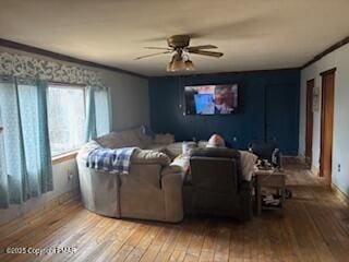 cinema with ceiling fan and light wood-type flooring