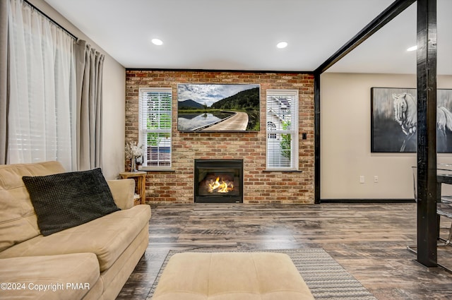 living room featuring recessed lighting, a brick fireplace, brick wall, and wood finished floors