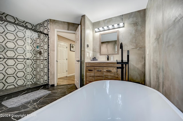 bathroom featuring a shower stall, a freestanding bath, and vanity