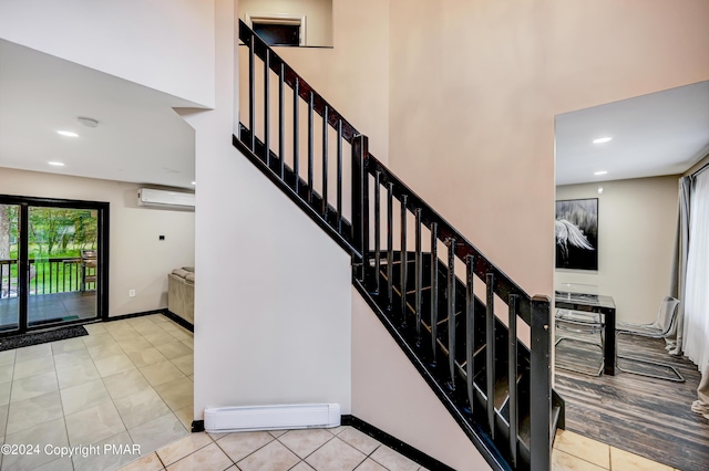 stairway with tile patterned flooring, recessed lighting, a baseboard heating unit, baseboards, and an AC wall unit