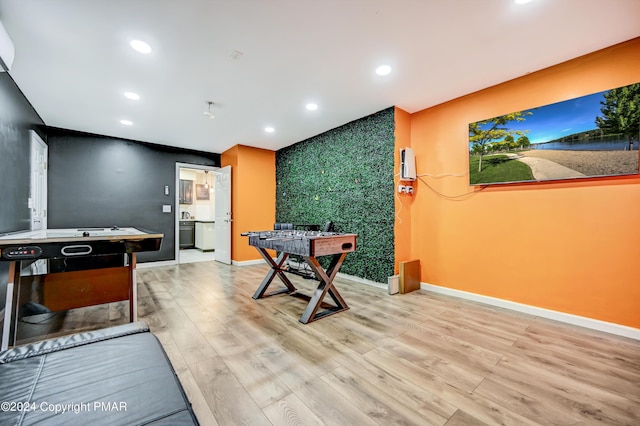 game room featuring baseboards, wood finished floors, and recessed lighting